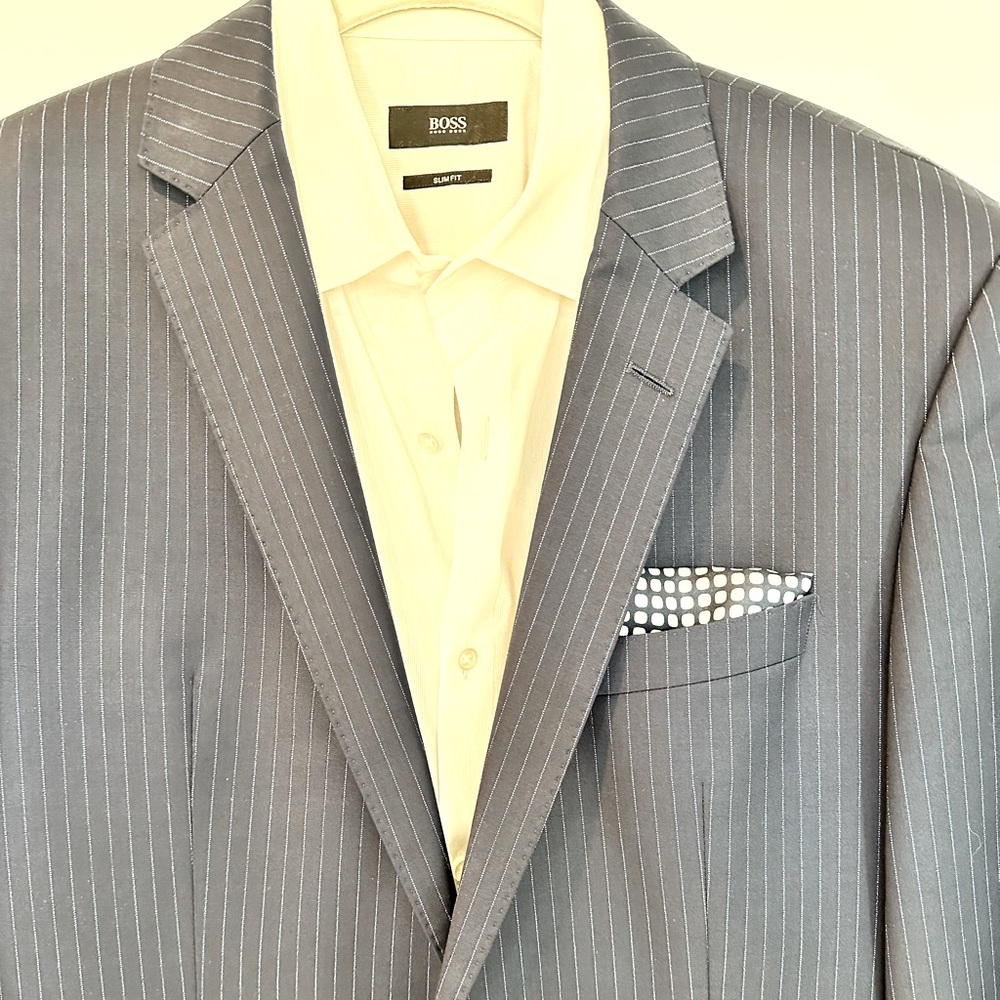 Men’s dark navy pinstripe Hugo boss suit. Formfitting with the ability to tailor